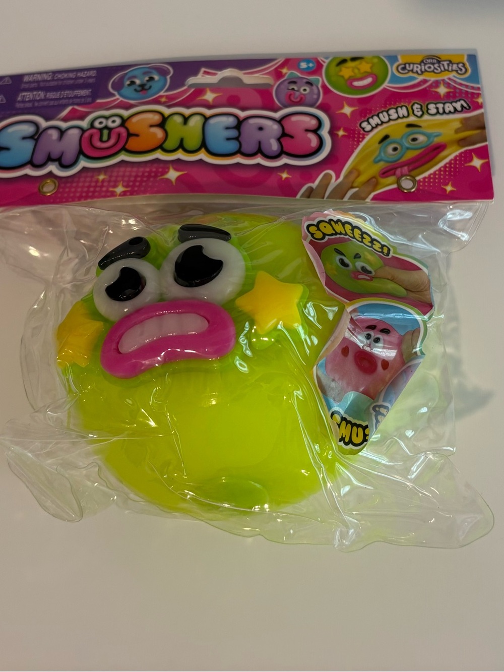 Smushers Neon Yellow Emoji Squisher Toy with Pink Mouth and Black Brows